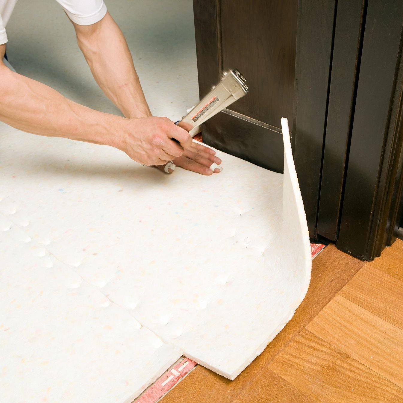 person installing underlayment - Carpet Plus Flooring LLC
