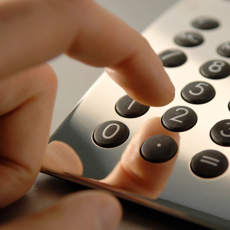 closeup of a hand using an analogue calculator from Carpet Plus Inc in Crofton, MD