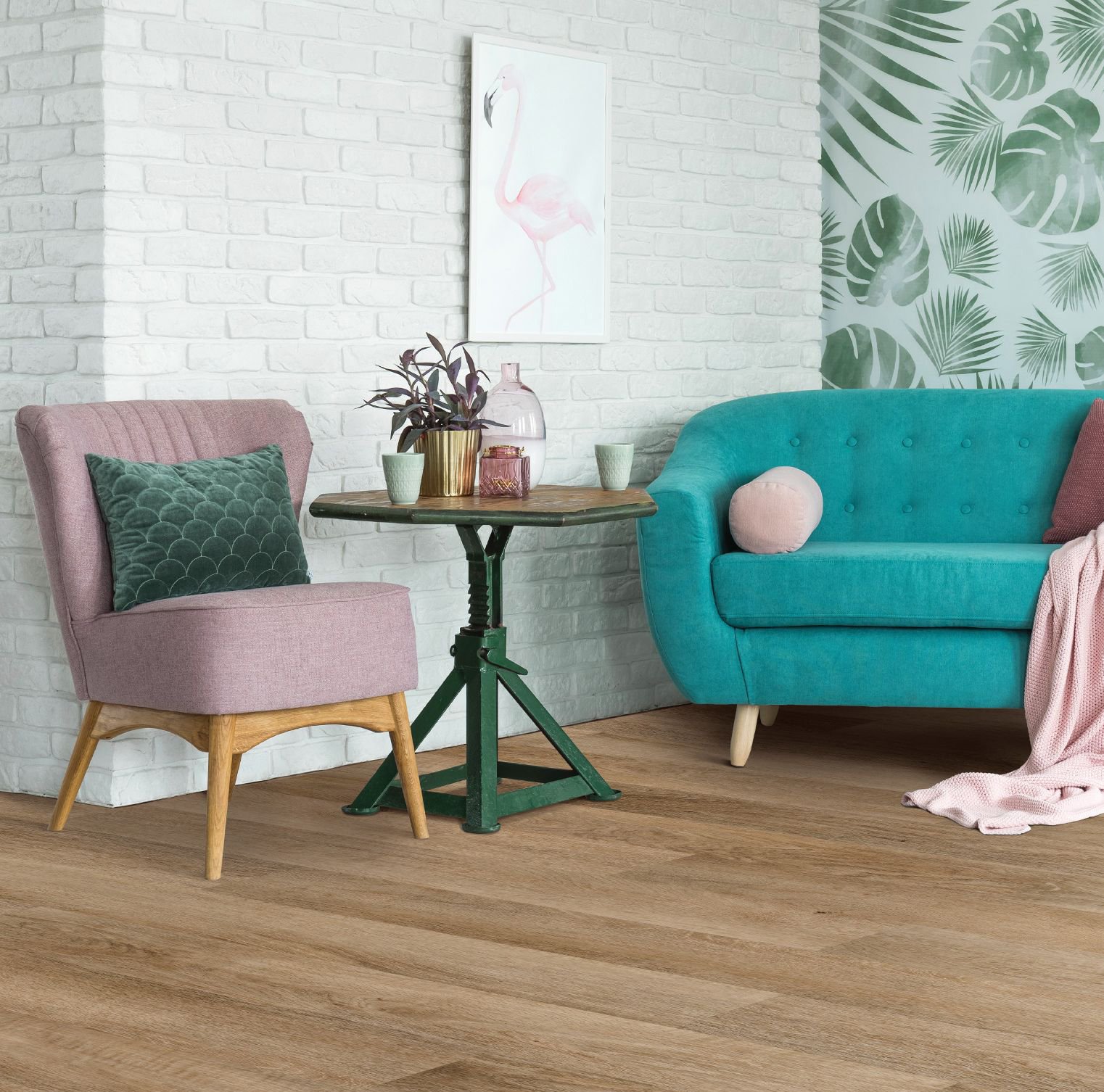 pink arm chair and teal couch on wood look flooring - Carpet Plus Flooring LLC