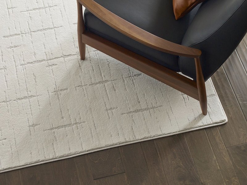 mid-century modern arm chair on white area rug - Carpet Plus Flooring LLC