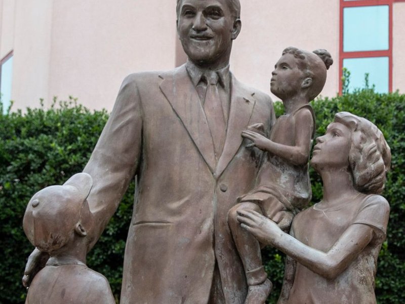 statues of a man and children - Carpet Plus Flooring LLC